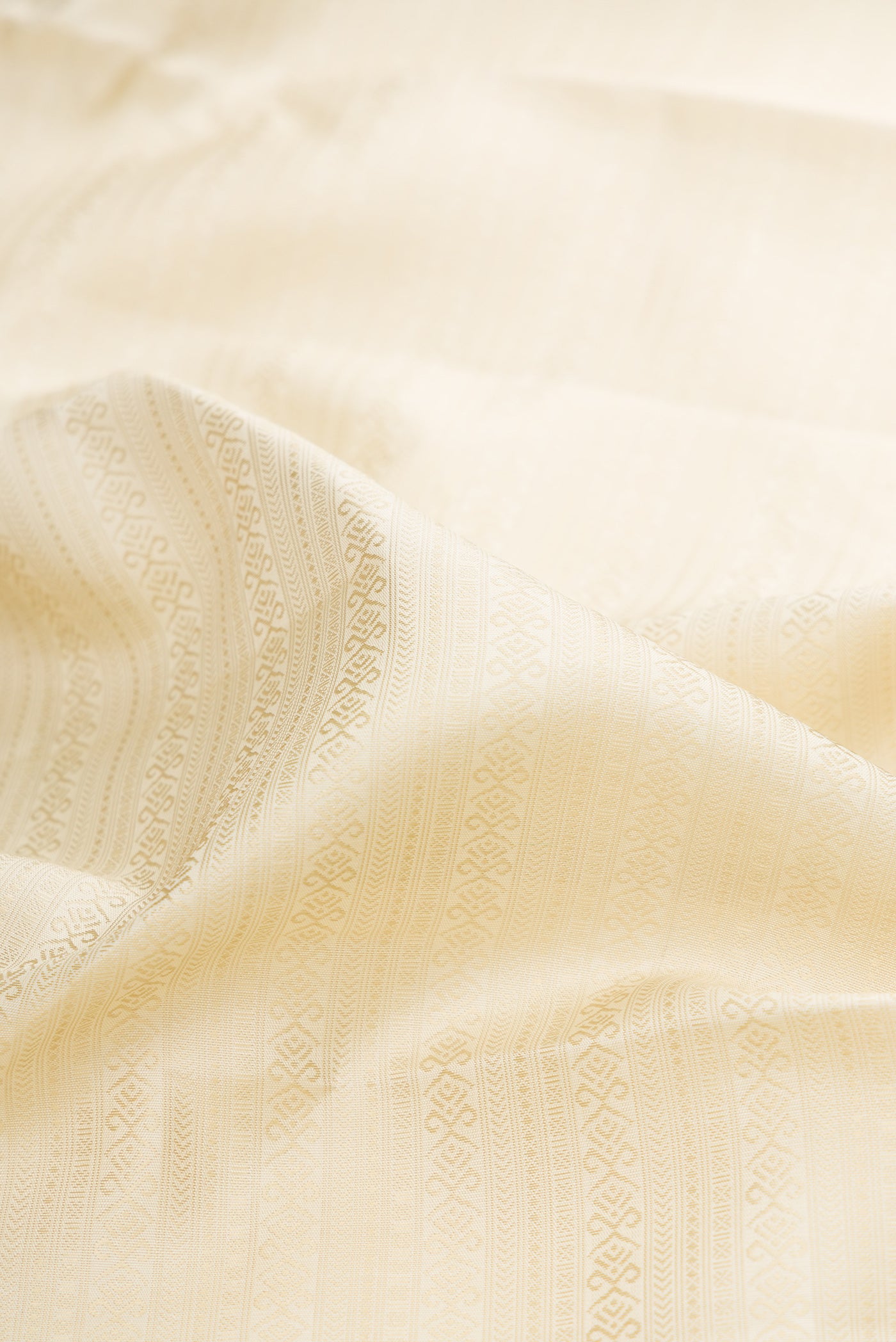 Close up of Pure Silk Pure Zari Off White Kanjivaram Saree with Jacquard design on the body and Zari And Thread Border.  displaying folds