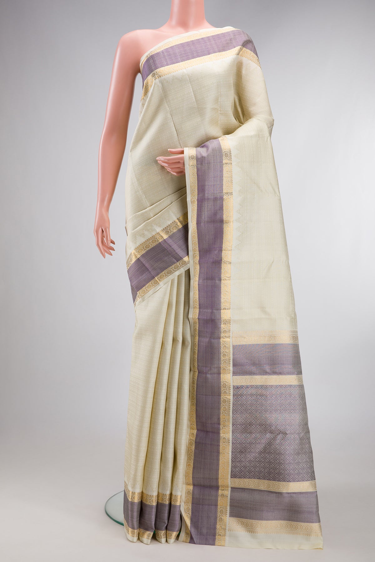 Pure Silk Pure Zari Off White Kanjivaram Saree with Jacquard design on the body and Zari And Thread Border.  displayed on a mannequin