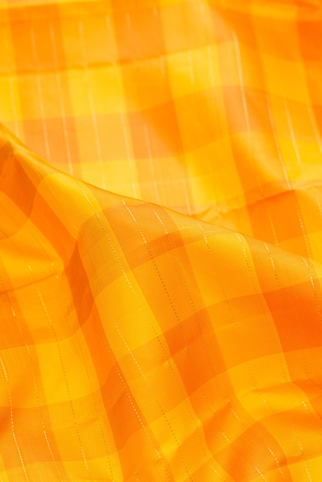 Close up of Pure Silk Pure Zari Yellow Kanjivaram Saree with Checked design on the body and Zari Border.  displaying folds