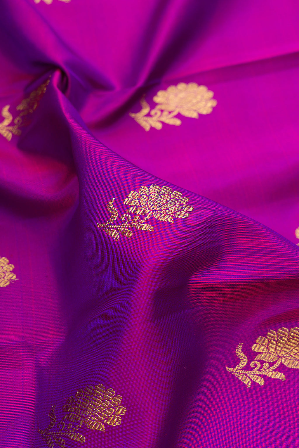 Close up of Pure Silk Pure Zari Purple Kanjivaram Saree with Zari Butta on the body and Fancy Border.  displaying folds