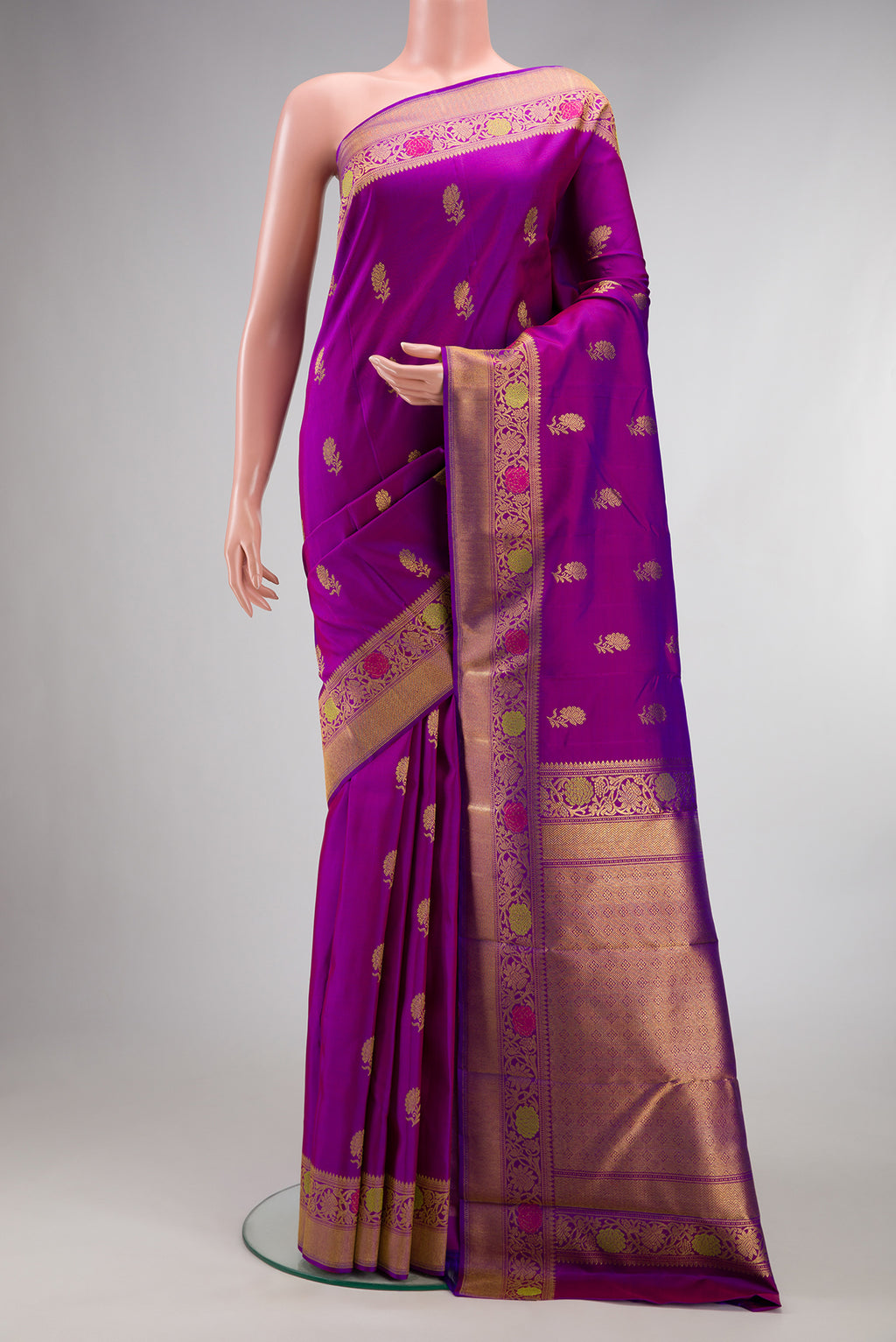 Pure Silk Pure Zari Purple Kanjivaram Saree with Zari Butta on the body and Fancy Border.  displayed on a mannequin