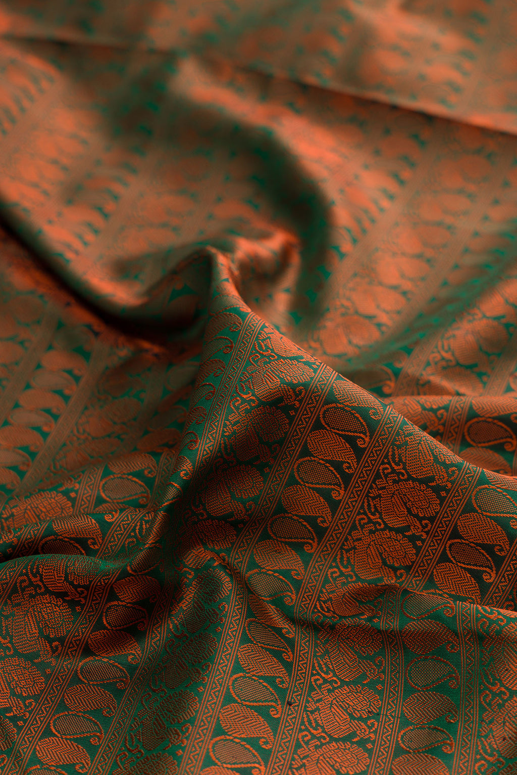 Close up of Pure Silk Green Kanjivaram Saree with Jacquard design on the body and Ganga Jamuna Border.  displaying folds
