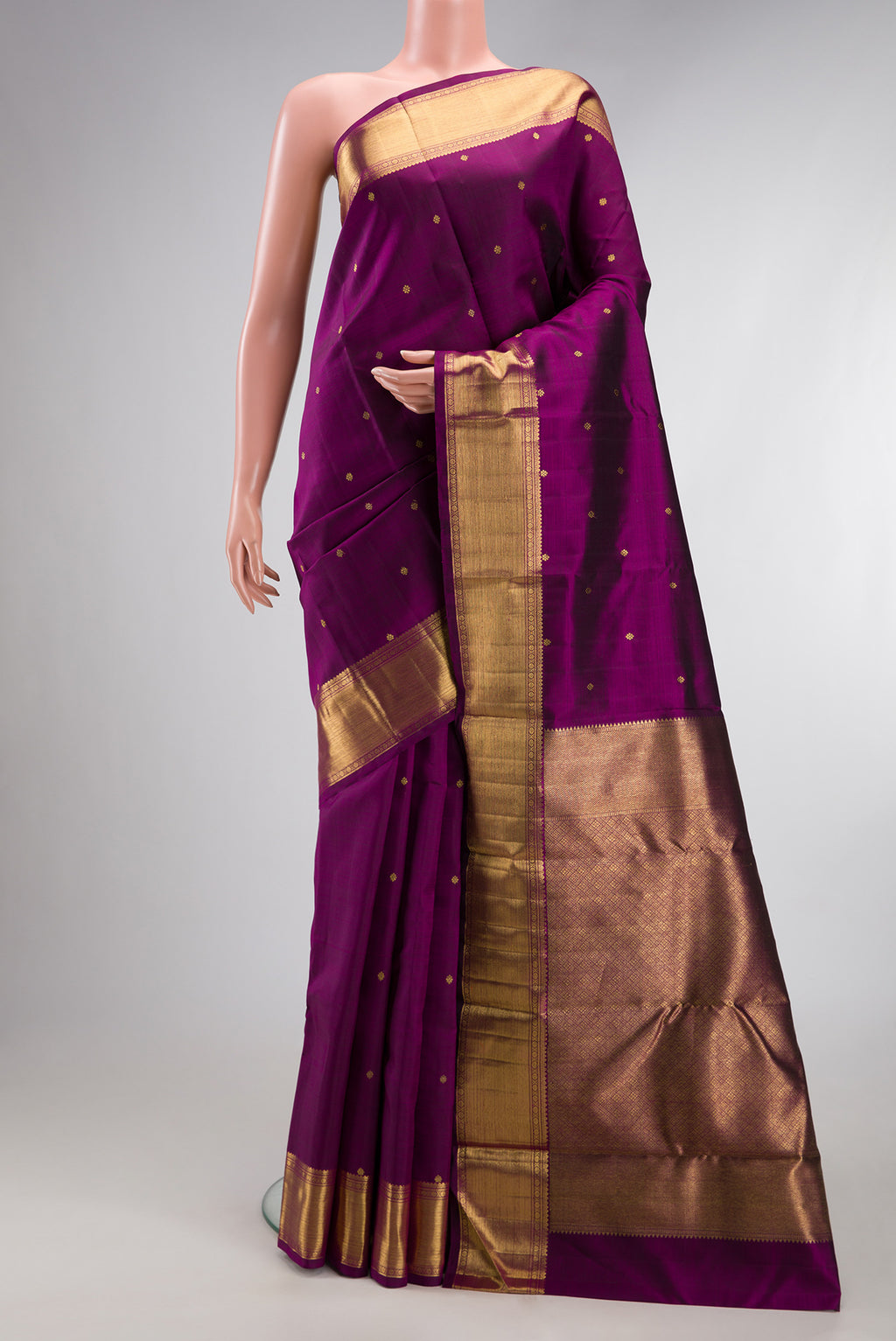 Pure Silk Pure Zari Magenta Kanjivaram Saree with Zari Butta on the body and Zari Border.  displayed on a mannequin