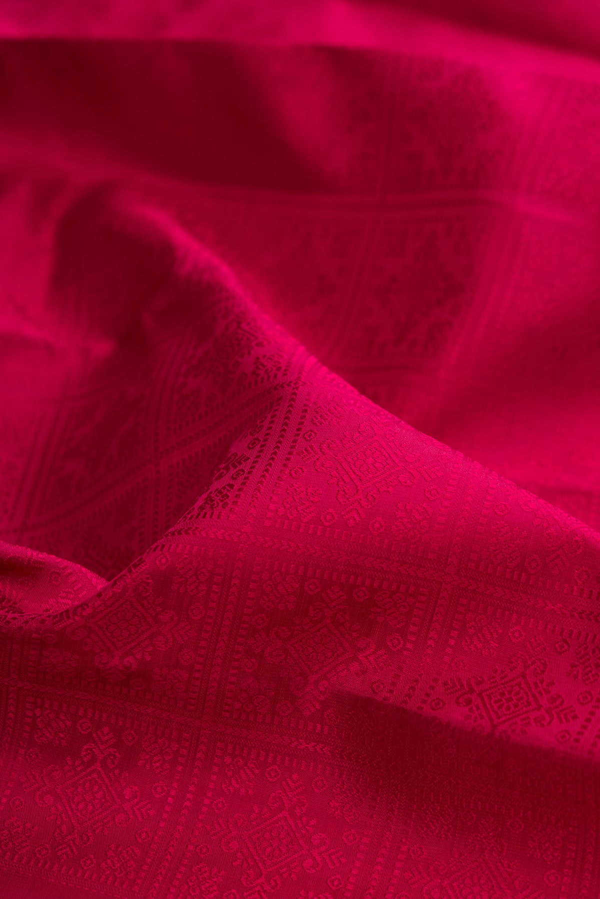 Close up of Pure Silk Pure Zari Maroon Kanjivaram Saree with Jacquard design on the body and Thin Zari Line.  displaying folds
