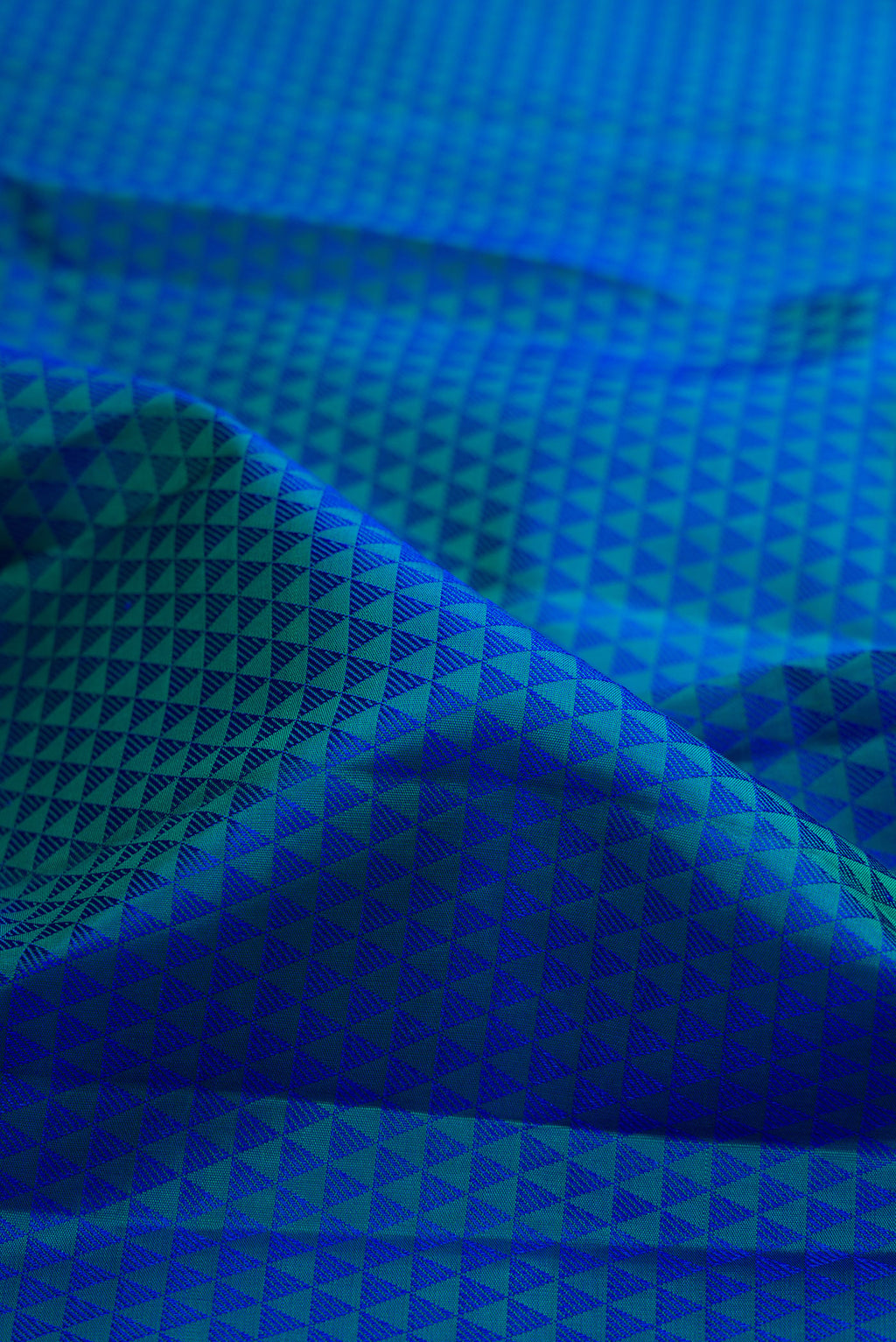 Close up of Peacock Blue Dual Tone Kanjivaram Silk Saree with Jacquard design on the body and Zari Border.  displaying folds
