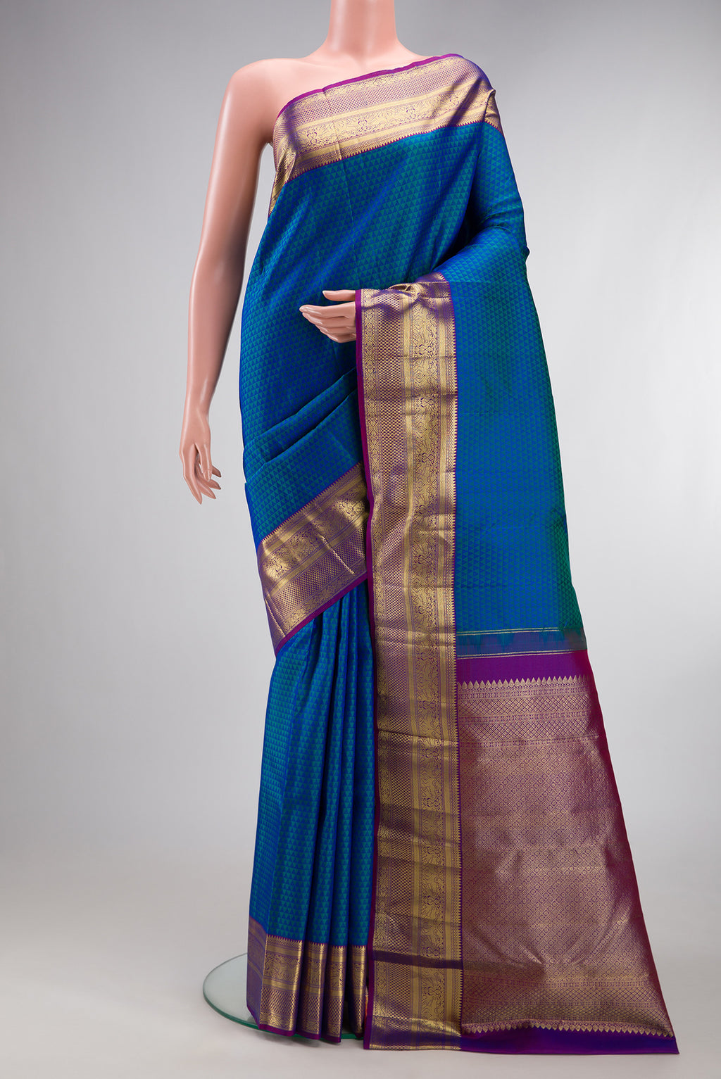 Peacock Blue Dual Tone Kanjivaram Silk Saree with Jacquard design on the body and Zari Border.  displayed on a mannequin