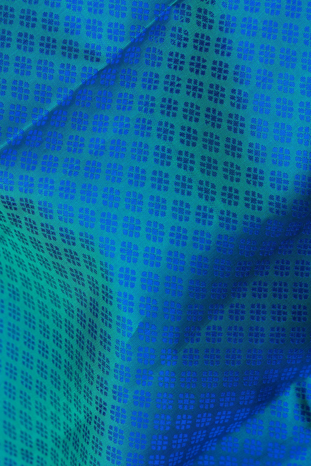 Close up of Pure Silk Peacock Blue Dual Tone Kanjivaram Saree with Jacquard design on the body and Zari Border.  displaying folds