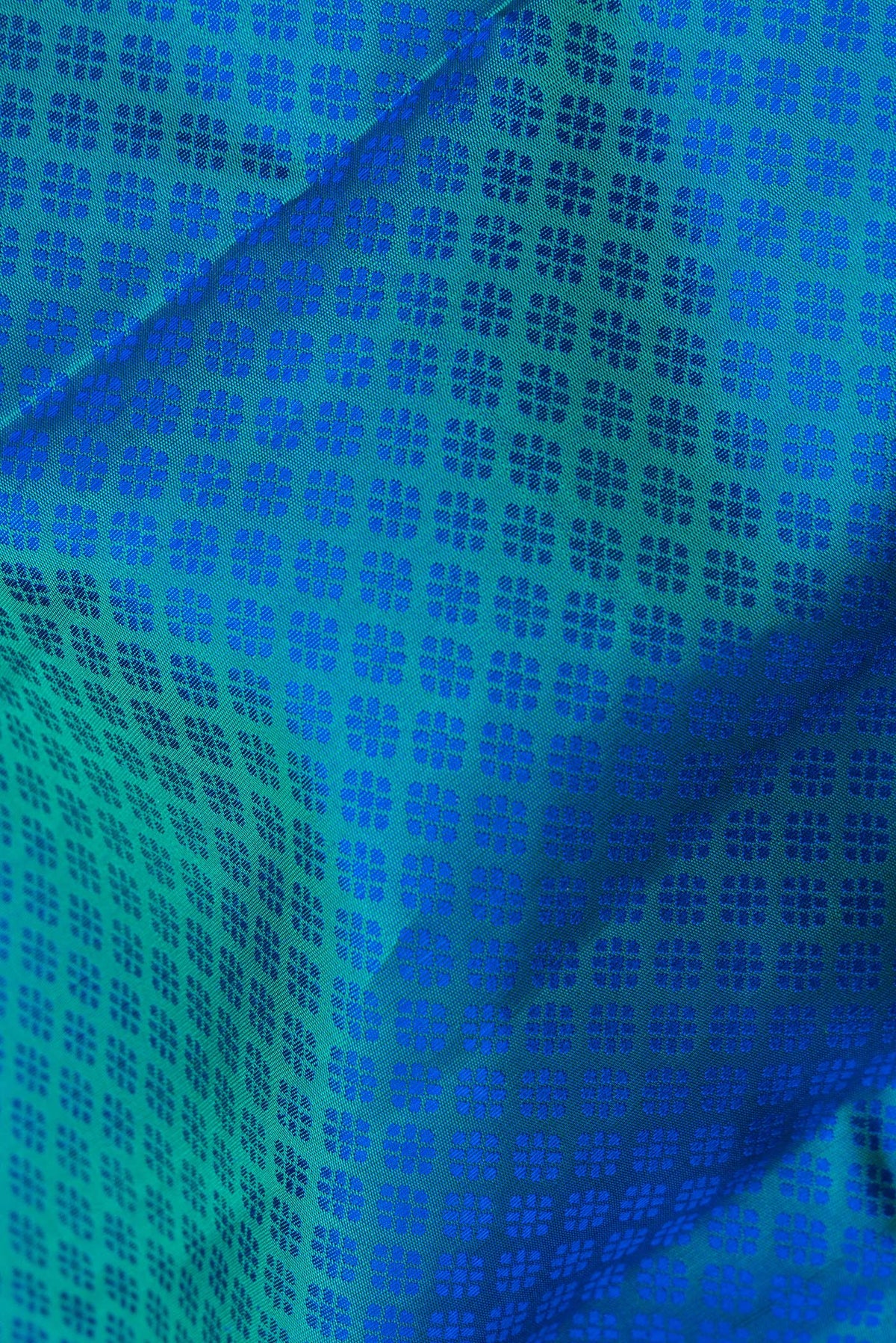 Close up of Pure Silk Peacock Blue Dual Tone Kanjivaram Saree with Jacquard design on the body and Zari Border.  displaying folds