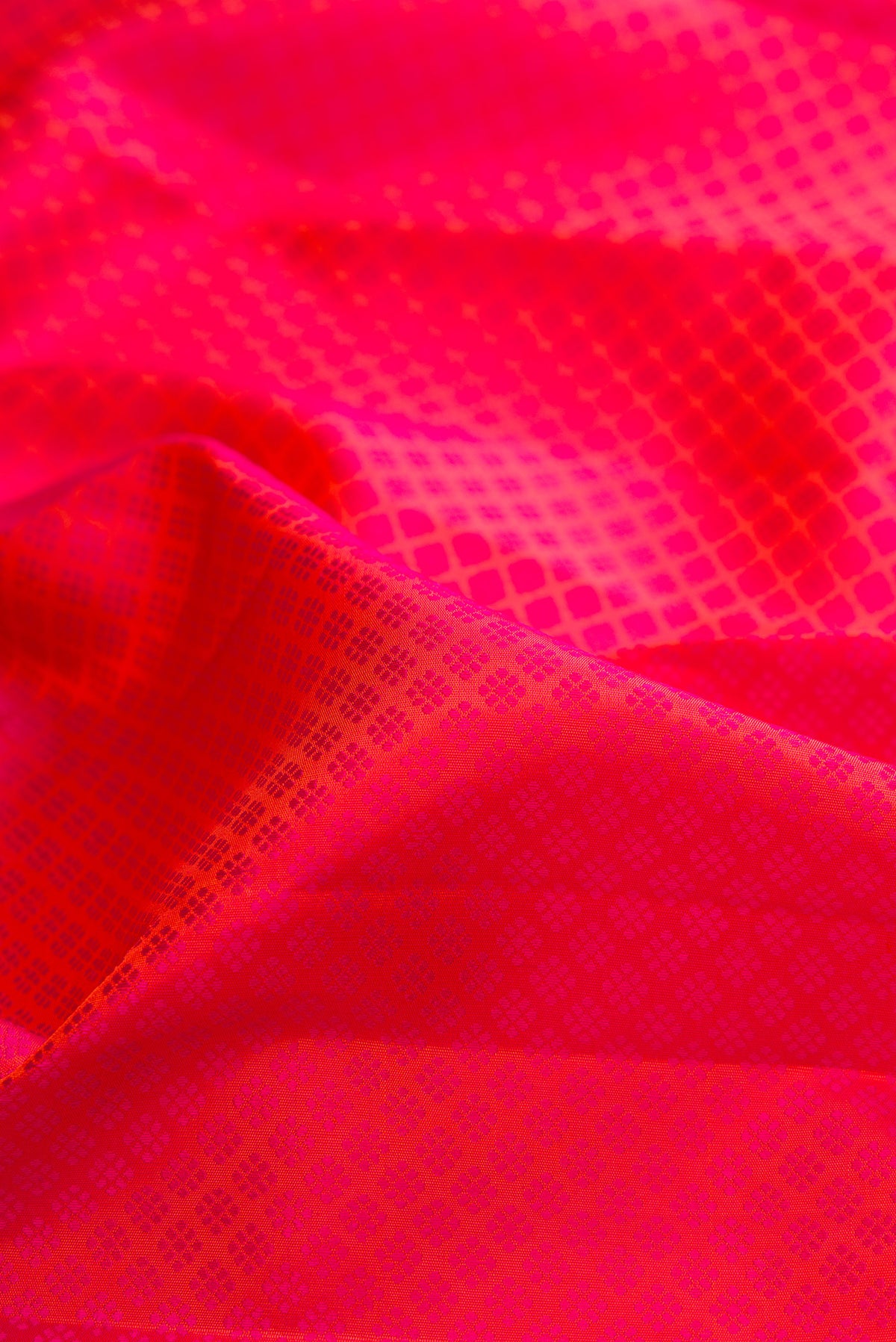 Close up of Pink Dual Tone Kanjivaram Silk Saree with Jacquard design on the body and Zari Border.  displaying folds