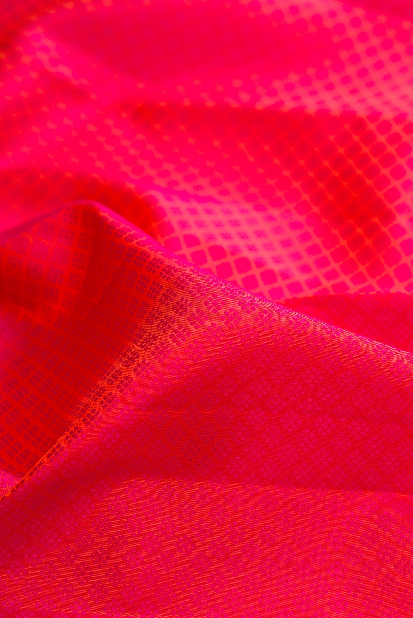 Close up of Pink Dual Tone Kanjivaram Silk Saree with Jacquard design on the body and Zari Border.  displaying folds