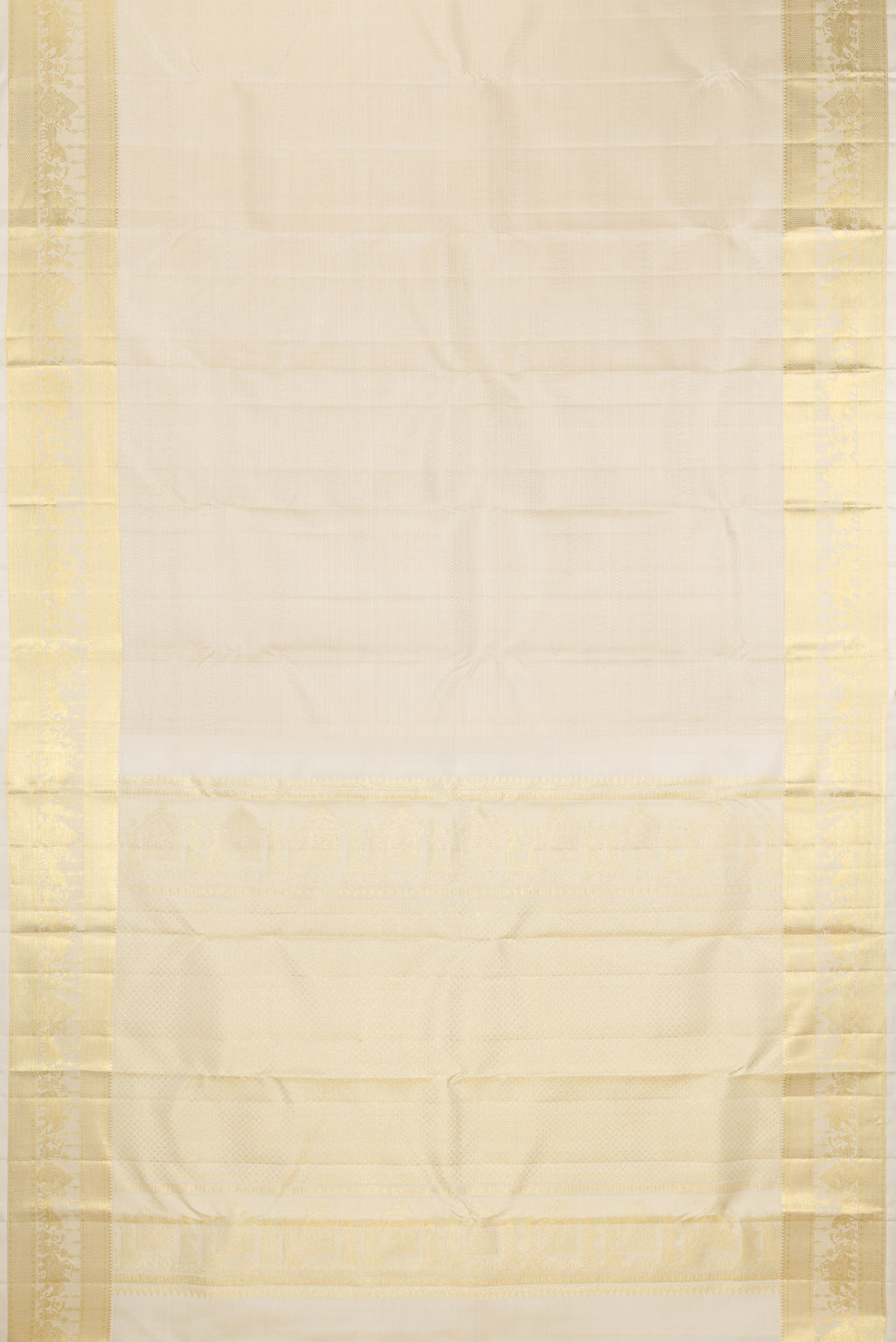 Flat view of Cream Kanjivaram Silk Saree with Jacquard design on the body and Zari Border. 