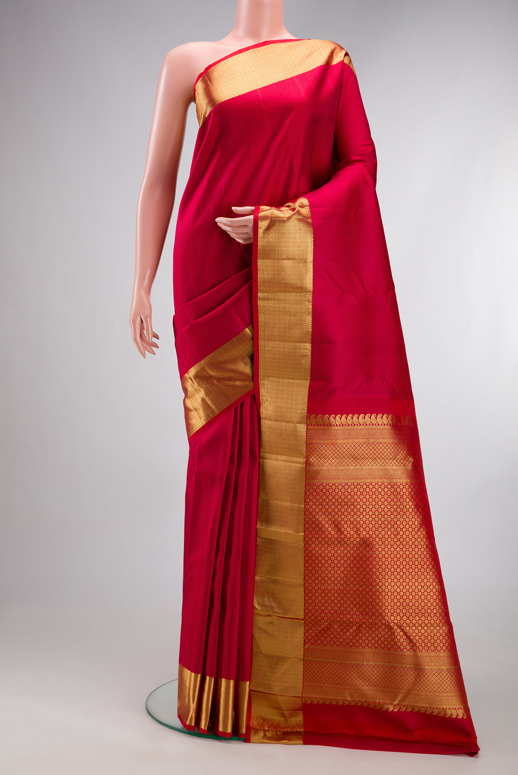Red Kanjivaram Silk Saree with Jacquard design on the body and Zari Border.  displayed on a mannequin