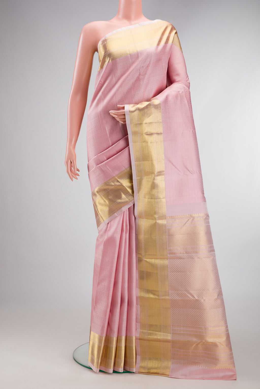 Rose pink Kanjivaram Silk Saree with Jacquard design on the body and Zari Border.  displayed on a mannequin