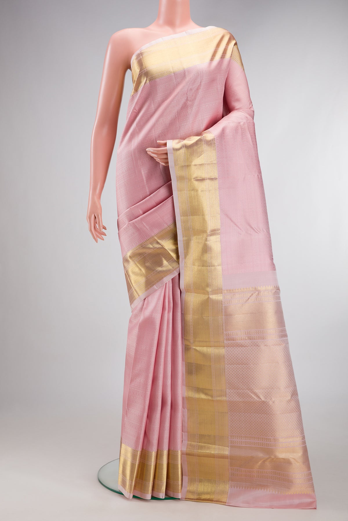 Rose pink Kanjivaram Silk Saree with Jacquard design on the body and Zari Border.  displayed on a mannequin