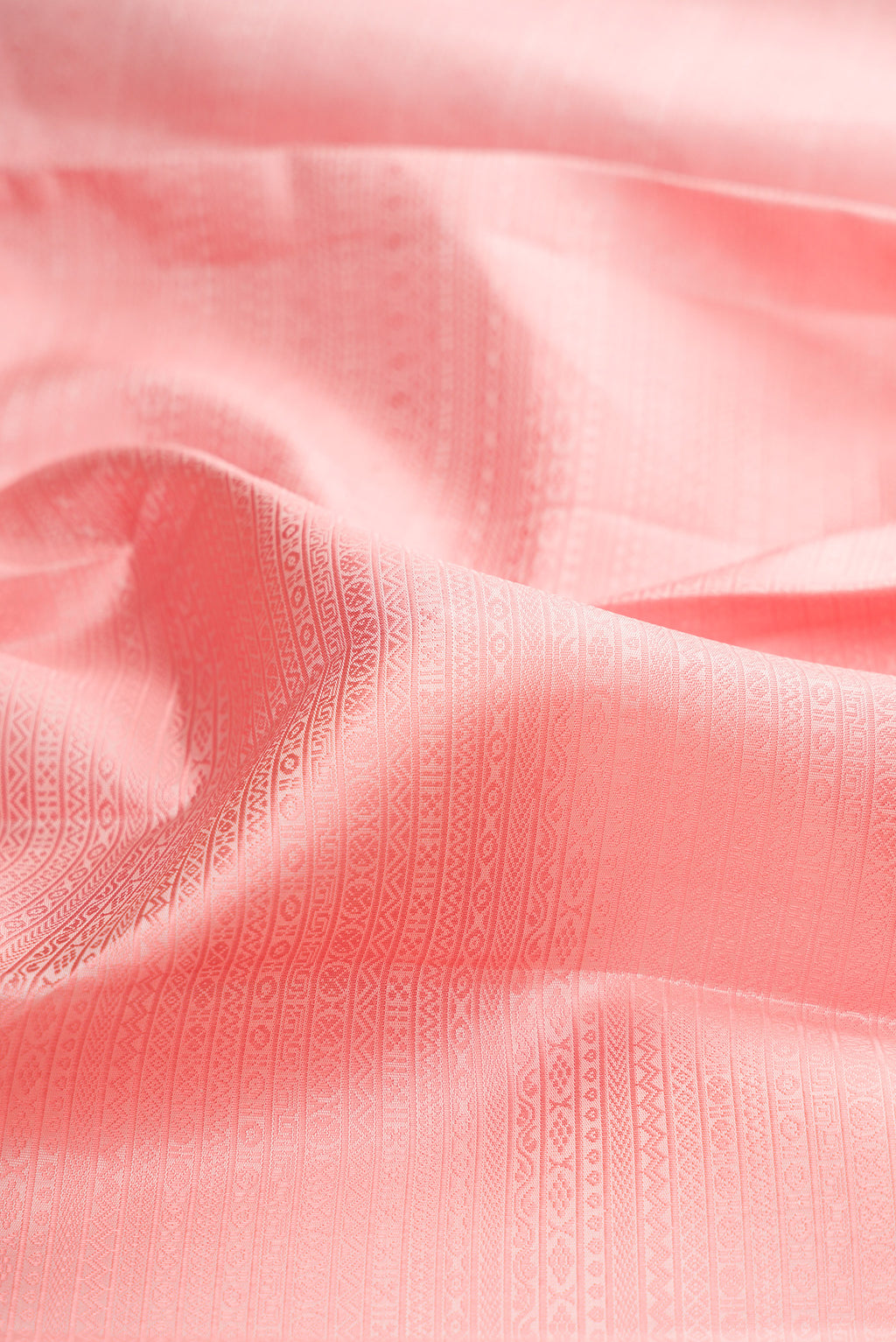 Close up of Golden Peach Kanjivaram Silk Saree with Jacquard design on the body and Zari Border.  displaying folds