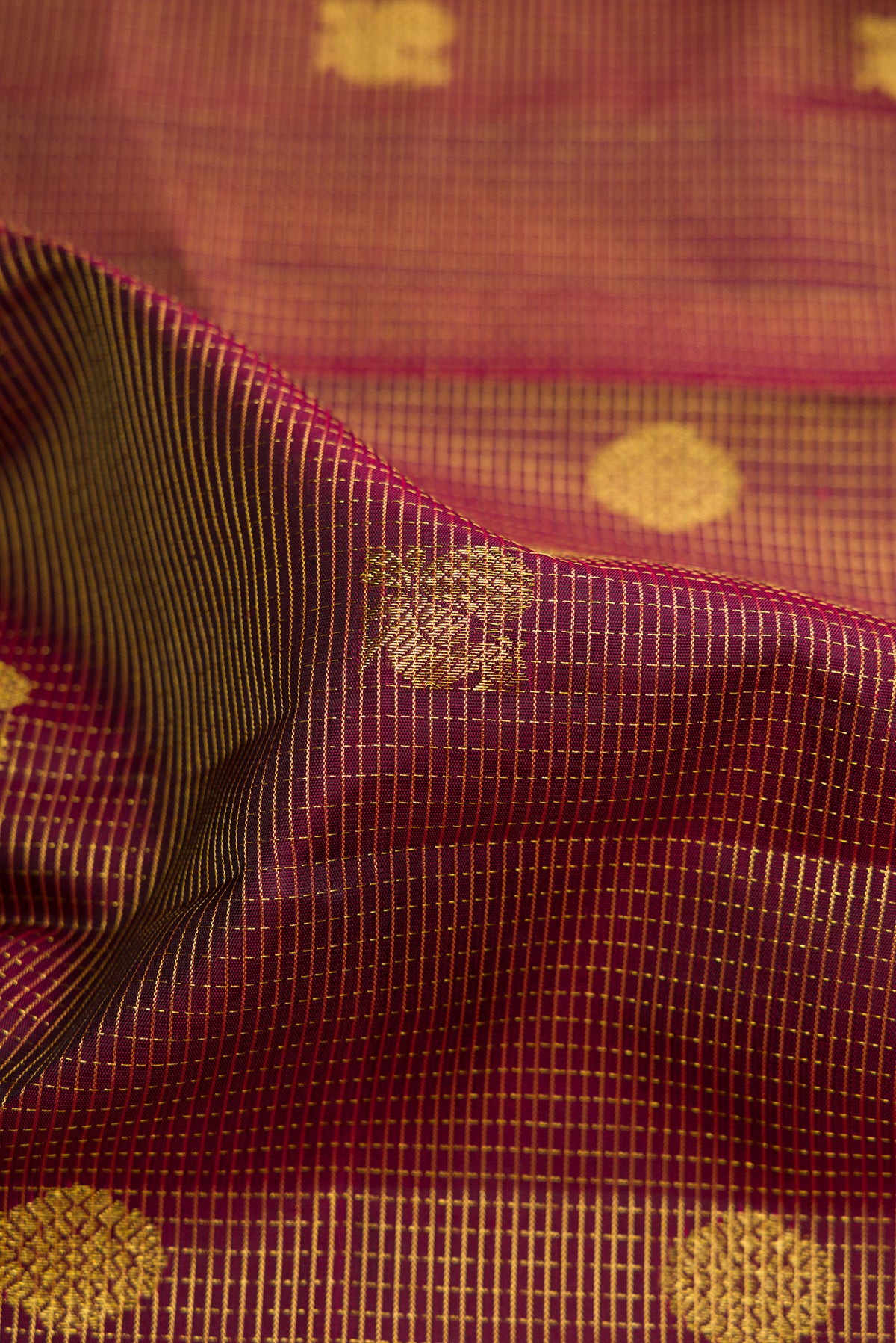Close up of Pure Silk Maroon Kanjivaram Saree with Checked design on the body and Zari Border.  displaying folds