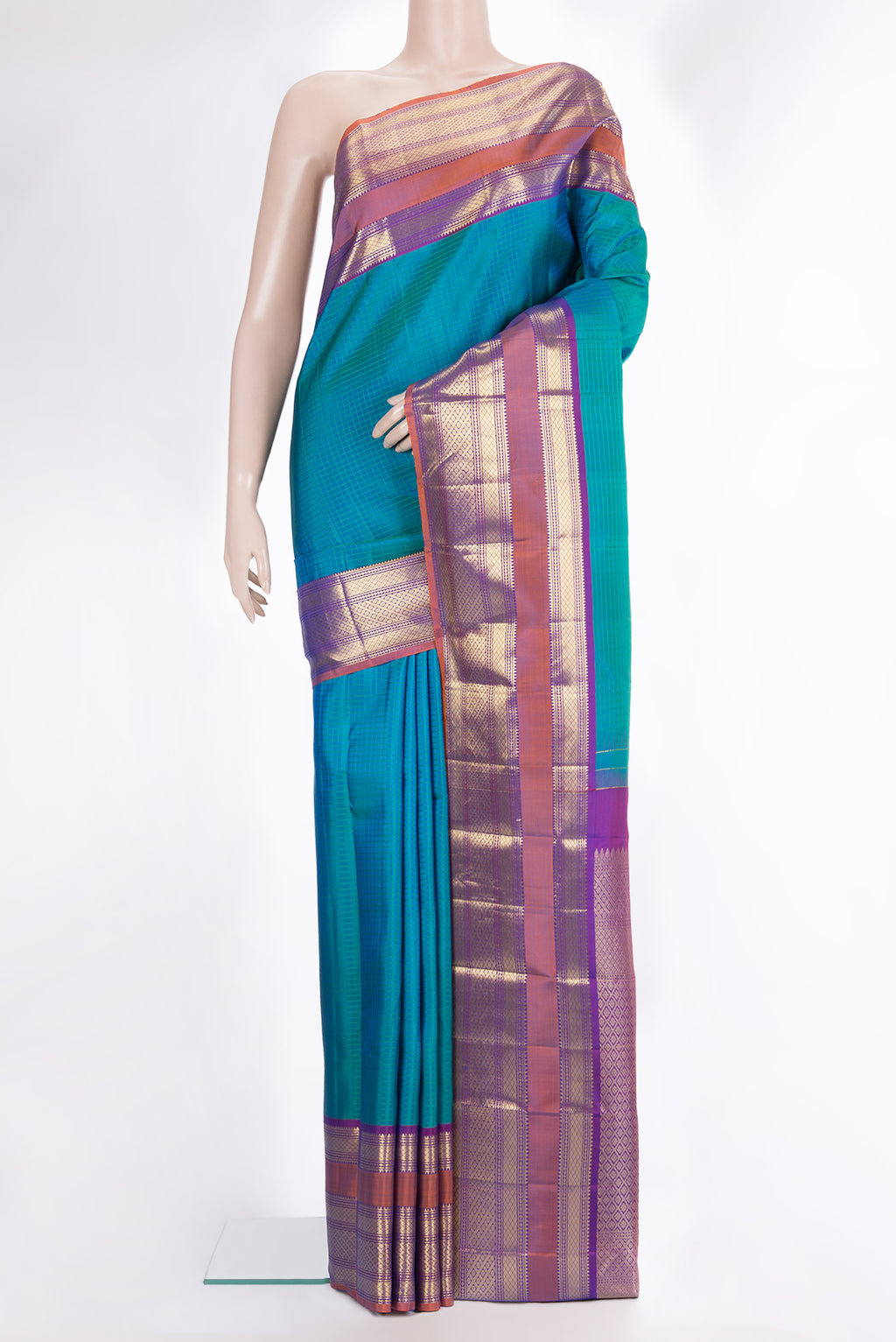 Pure Silk Peacock Blue Dual Tone Kanchipuram Saree with Checked design on the body and Zari Border.  displayed on a mannequin