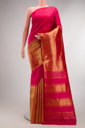 Pure Silk Pink Kanjivaram Saree with Plain Body and Rising Temple Border.  displayed on a mannequin