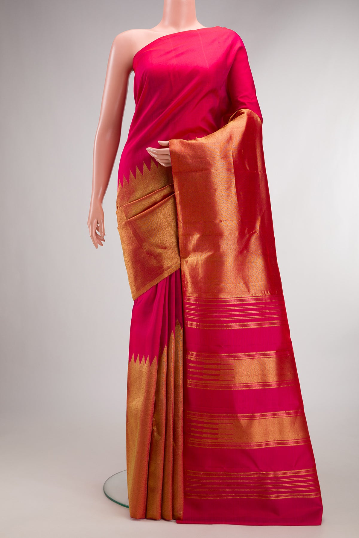 Pure Silk Pink Kanjivaram Saree with Plain Body and Rising Temple Border.  displayed on a mannequin