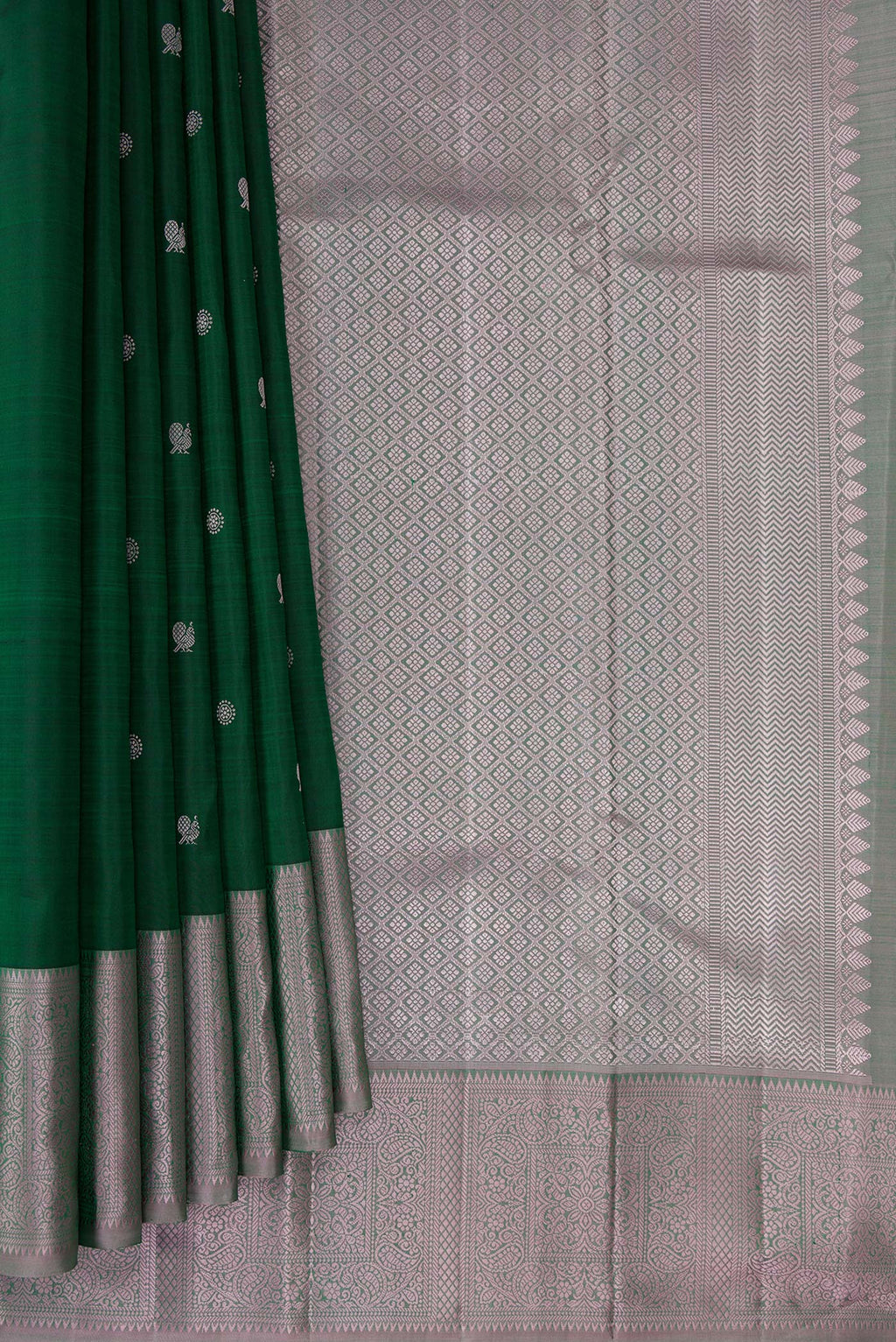 Pleats and pallu of Pure Silk Bottle Green Kanchipuram Saree with Thread Butta on the body and Thread Border. 