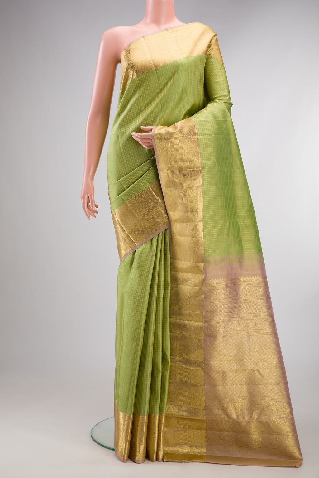 Pure Silk Pista Green Kanchipuram Saree with Checked design on the body and Zari Border.  displayed on a mannequin