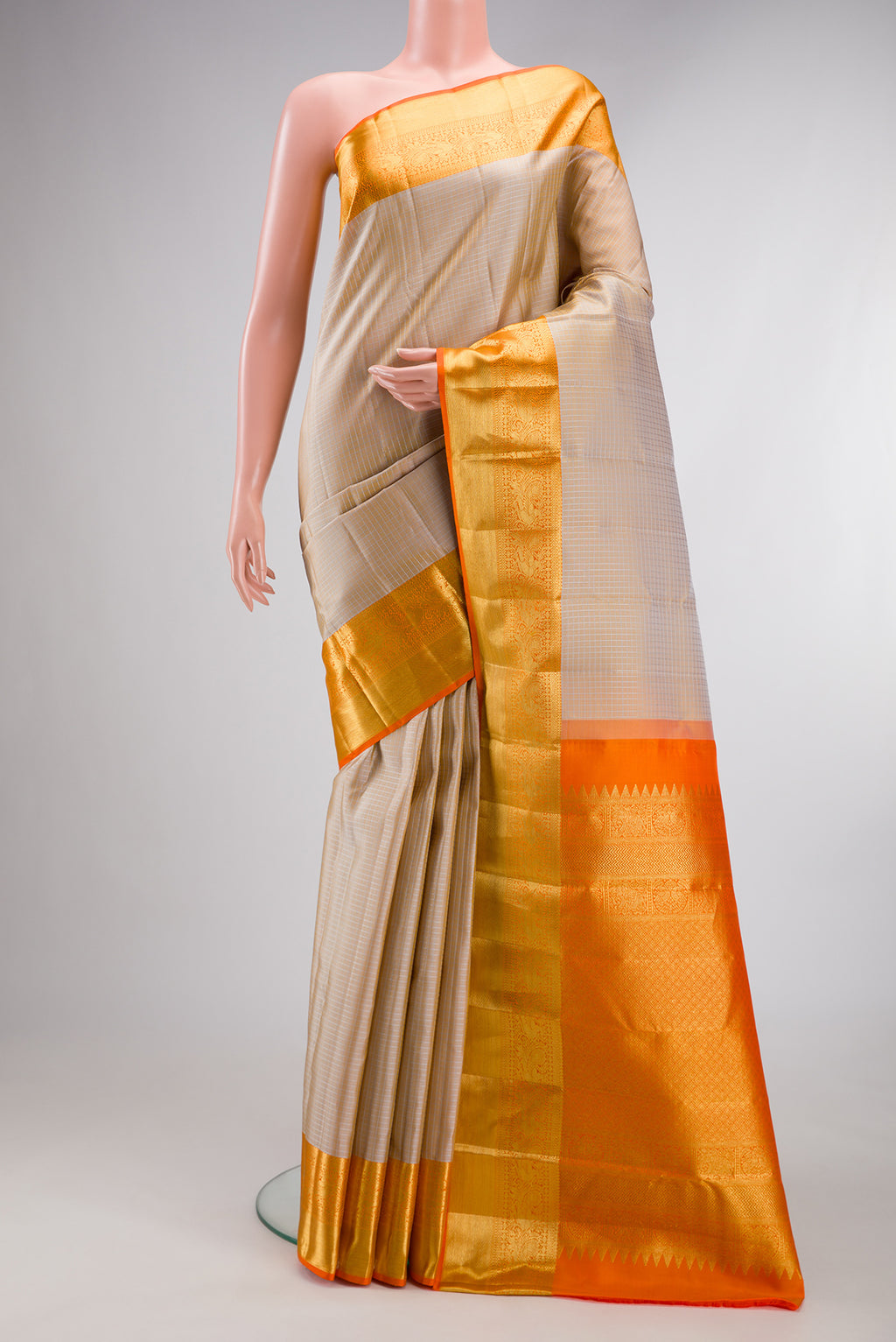 Pure Silk Beige Kanchipuram Saree with Checked design on the body and Zari Border.  displayed on a mannequin