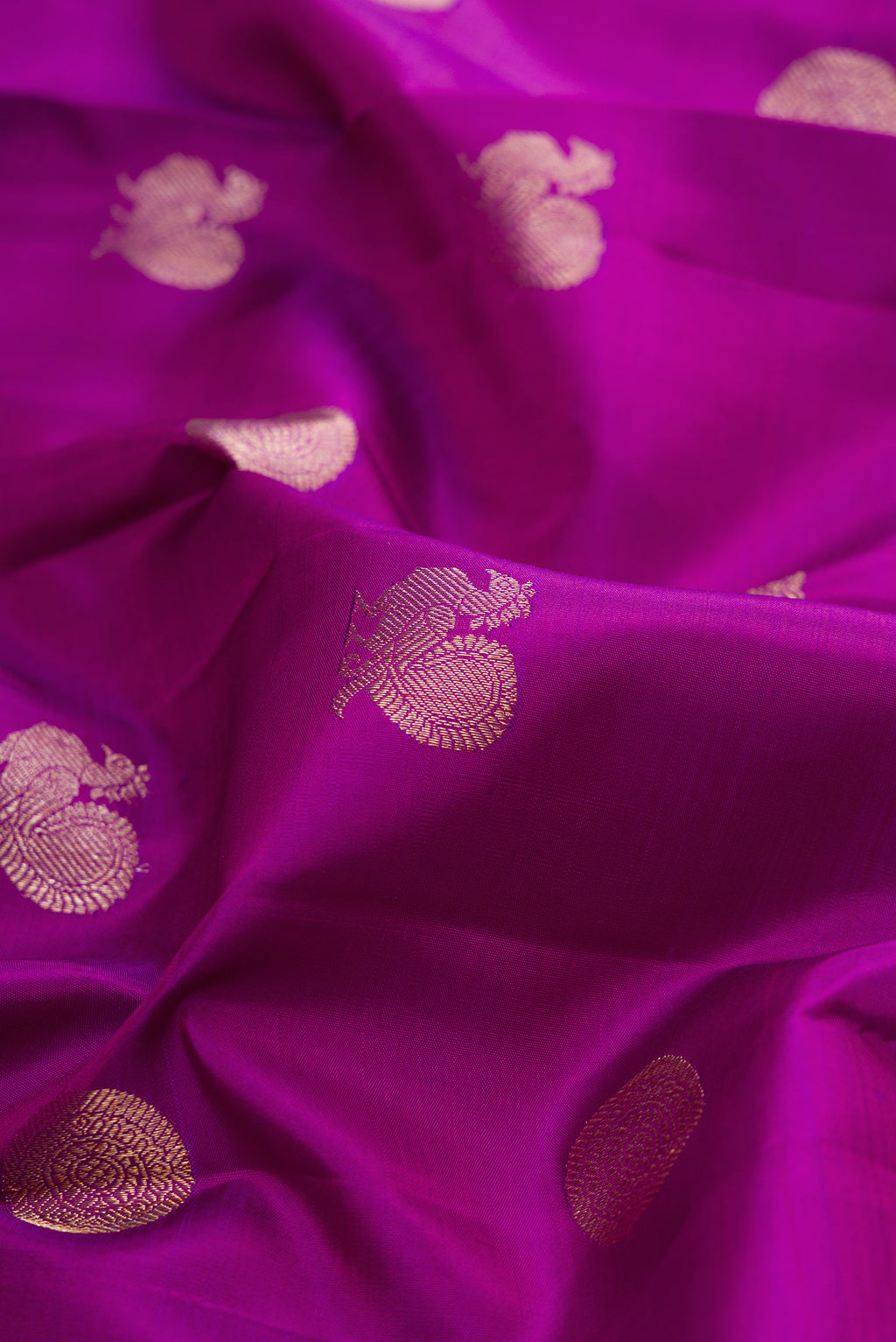 Close up of Pure Silk Purple Kanjivaram Saree with Zari Butta on the body and Zari Border.  displaying folds