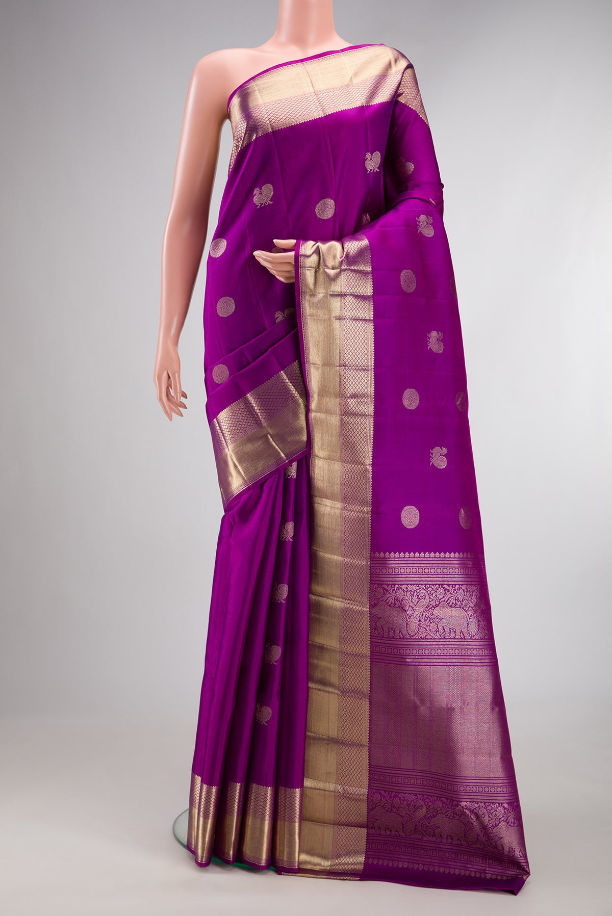 Pure Silk Purple Kanjivaram Saree with Zari Butta on the body and Zari Border.  displayed on a mannequin