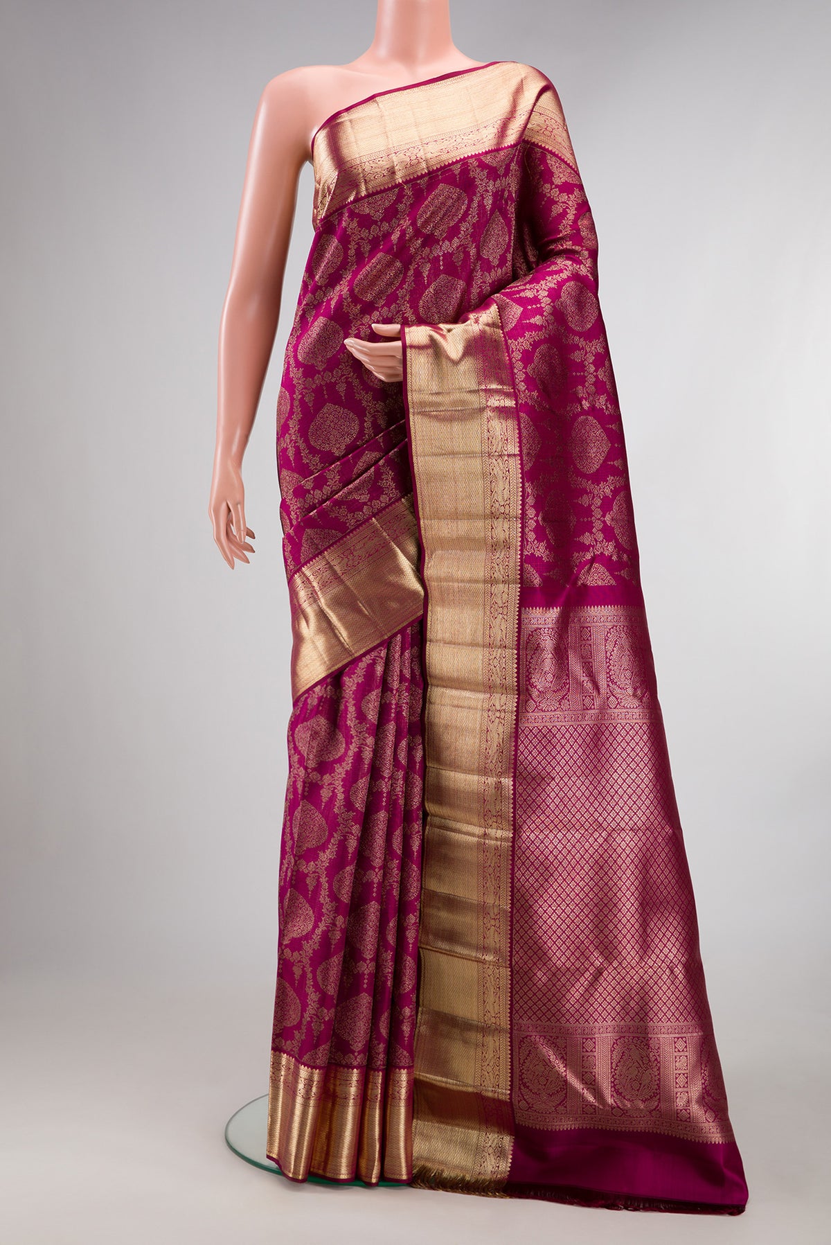 Pure Silk Magenta Kanchipuram Saree with Zari Brocade on the body and Zari Border.  displayed on a mannequin