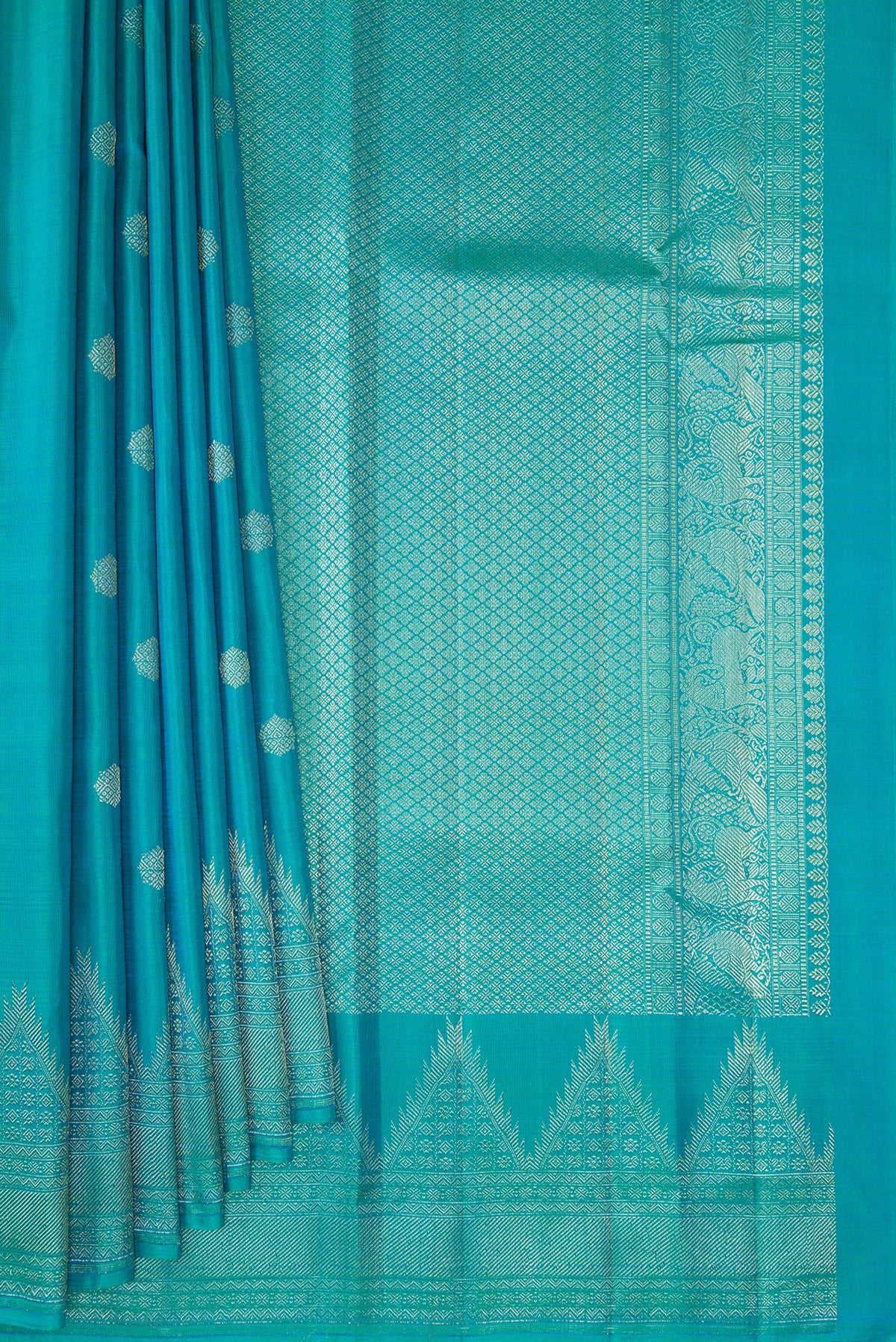 Pleats and pallu of Pure Silk Peacock Blue Kanchipuram Saree with Zari Butta on the body and Temple Border. 