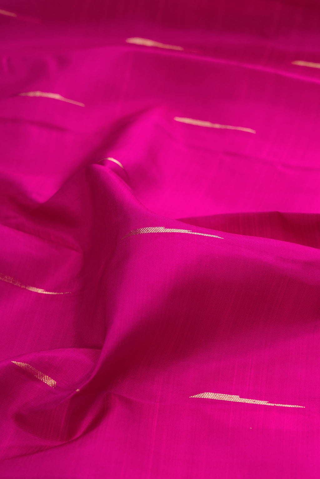 Close up of Pure Silk Magenta Kanjivaram Saree with Zari Butta on the body and Fancy Border.  displaying folds