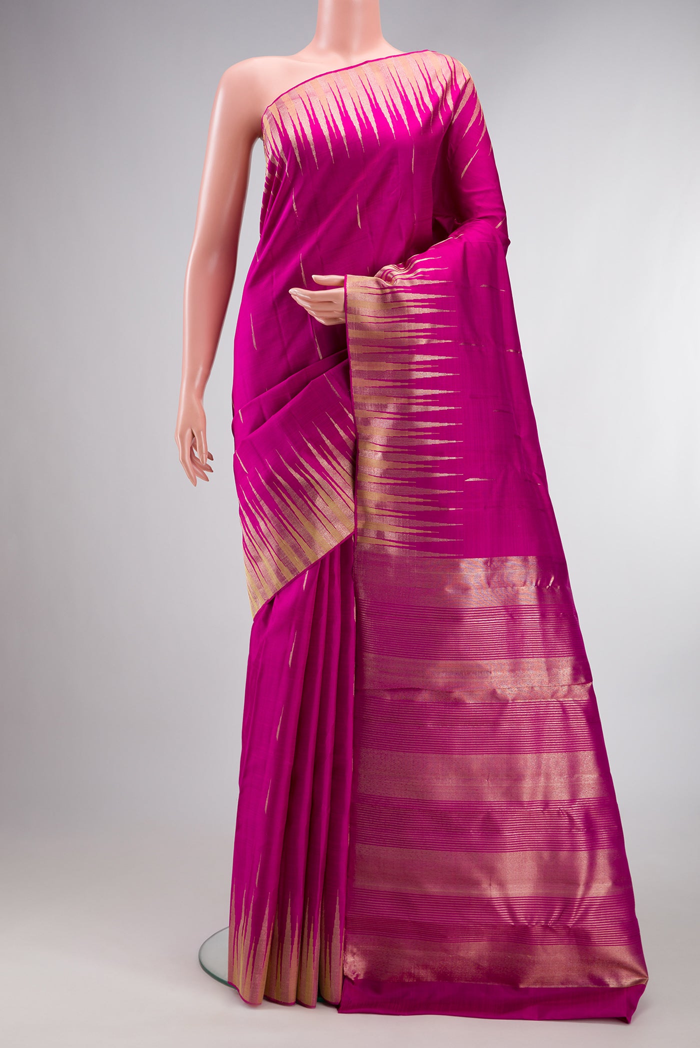 Pure Silk Magenta Kanjivaram Saree with Zari Butta on the body and Fancy Border.  displayed on a mannequin