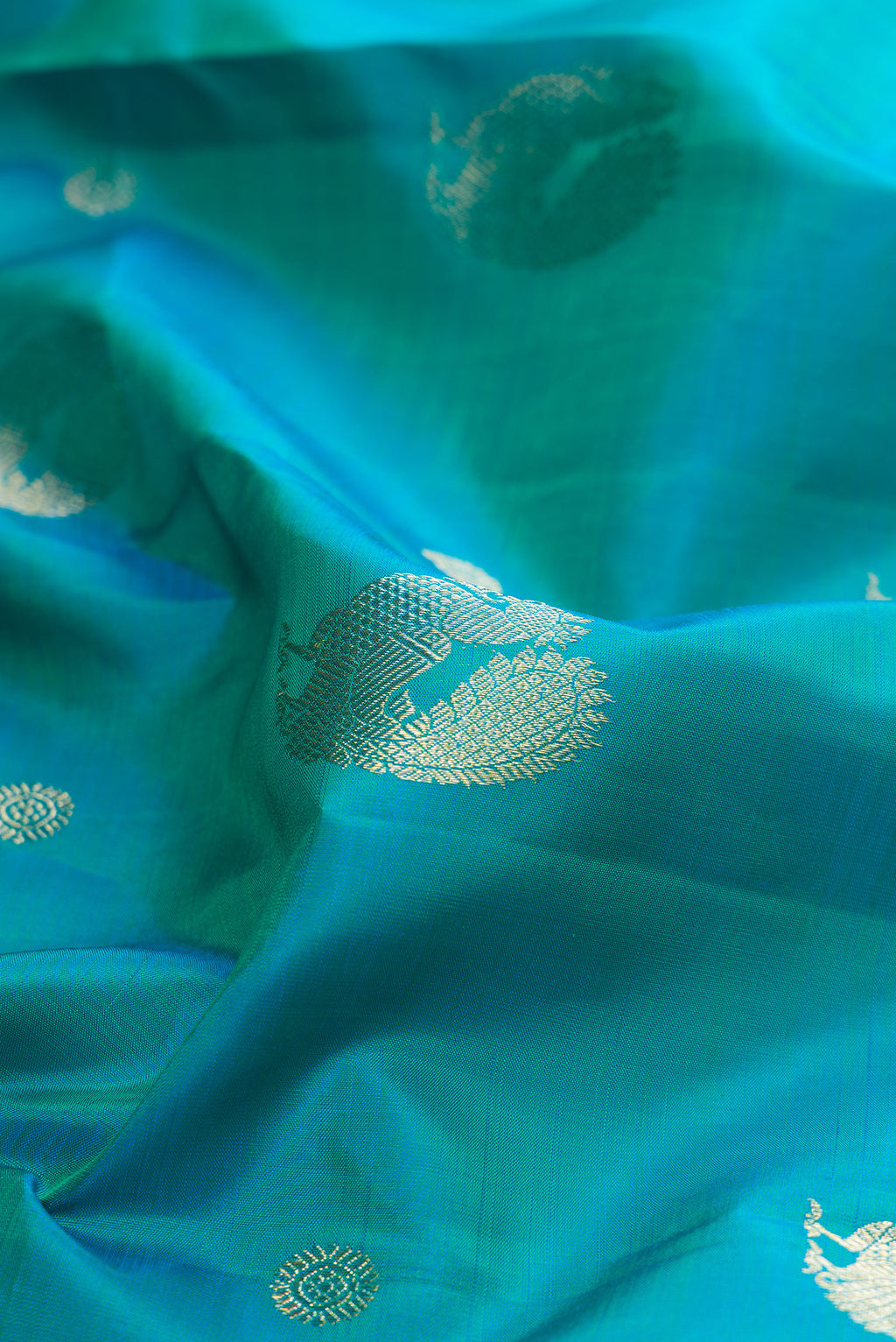 Close up of Pure Silk Blue Kanjivaram Saree with Zari Butta on the body and Zari Border.  displaying folds