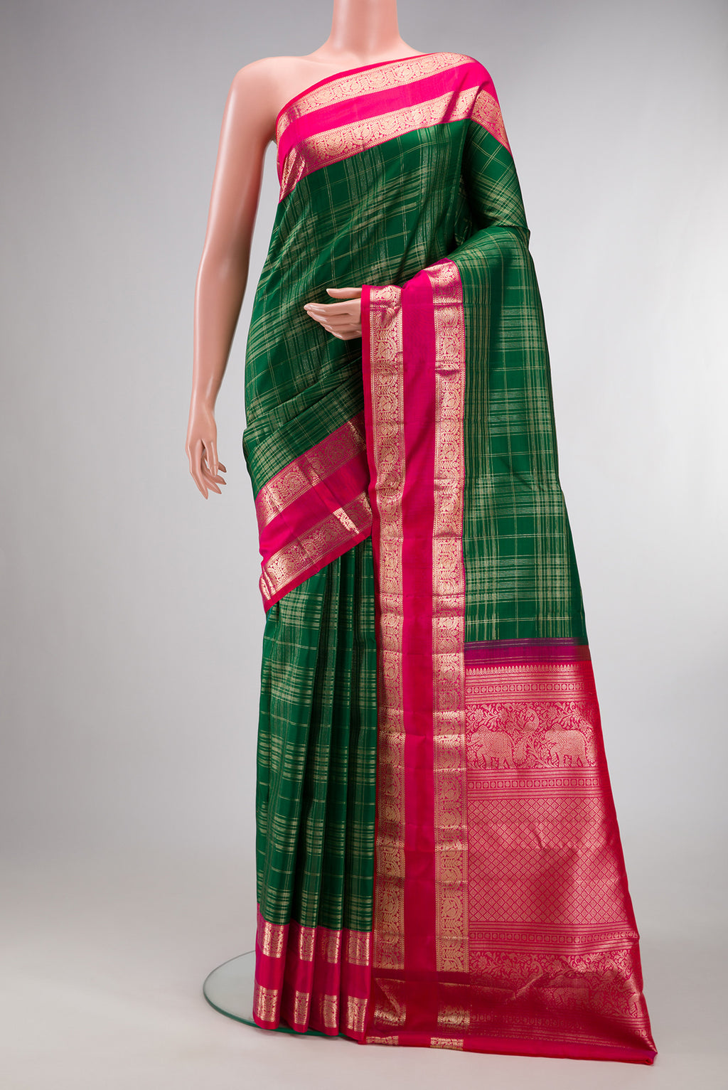 Pure Silk Green Kanchipuram Saree with Checked design on the body and Zari Border.  displayed on a mannequin