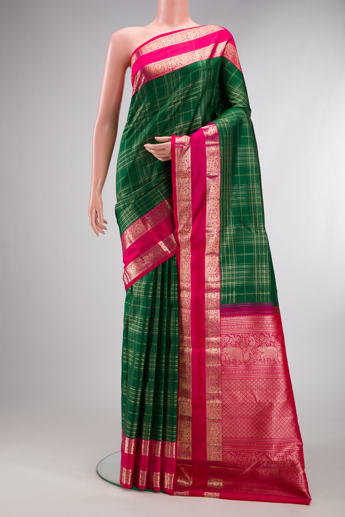 Pure Silk Green Kanchipuram Saree with Checked design on the body and Zari Border.  displayed on a mannequin