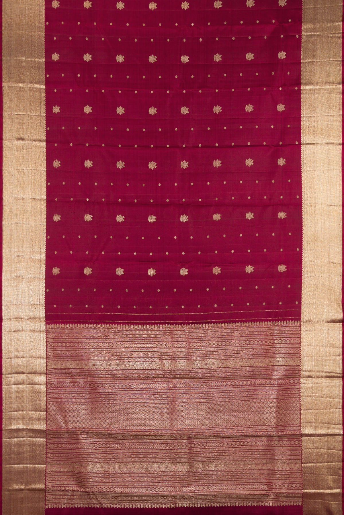 Flat view of Pure Silk Maroon Kanjivaram Saree with Zari Butta on the body and Zari Border. 