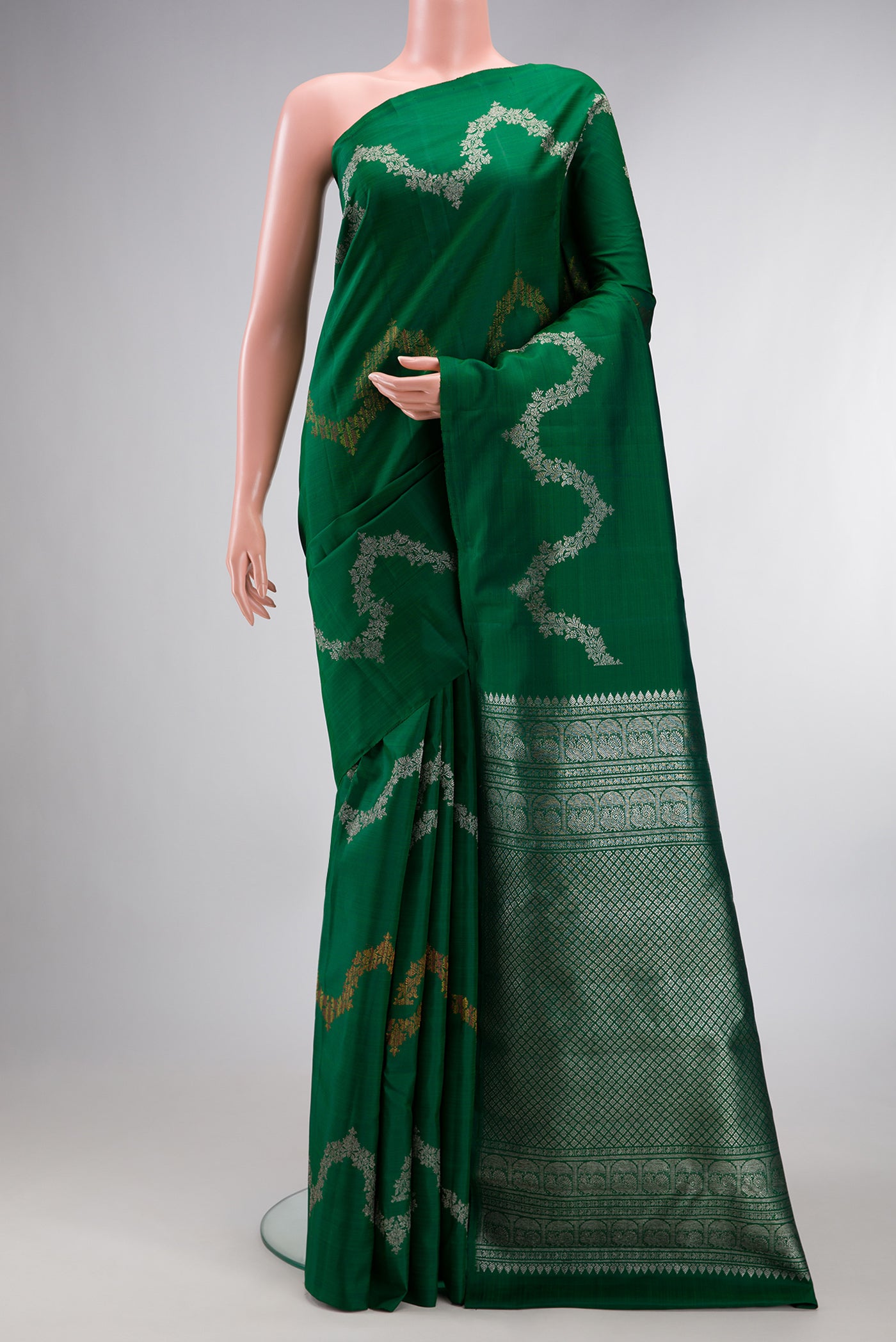 Pure Silk Bottle Green Kanjivaram Saree with Zig Zag design on the body and Without Border.  displayed on a mannequin