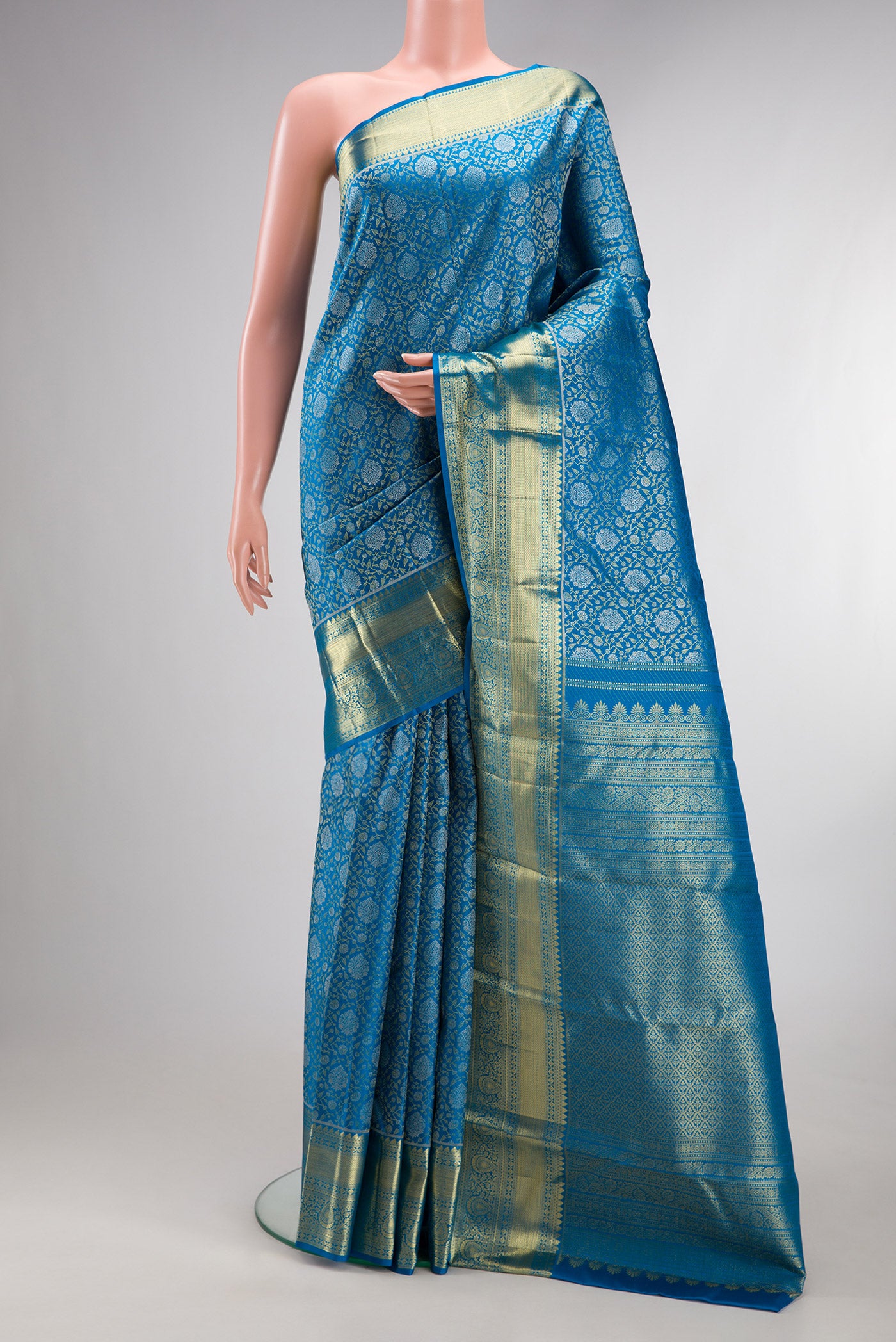 Pure Silk Peacock Blue Kanchipuram Saree with Zari Brocade on the body and Zari Border.  displayed on a mannequin
