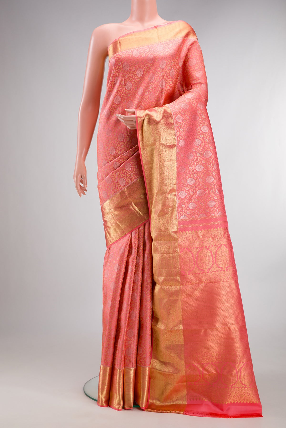 Pure Silk Coral Kanchipuram Saree with Zari Brocade on the body and Zari Border.  displayed on a mannequin
