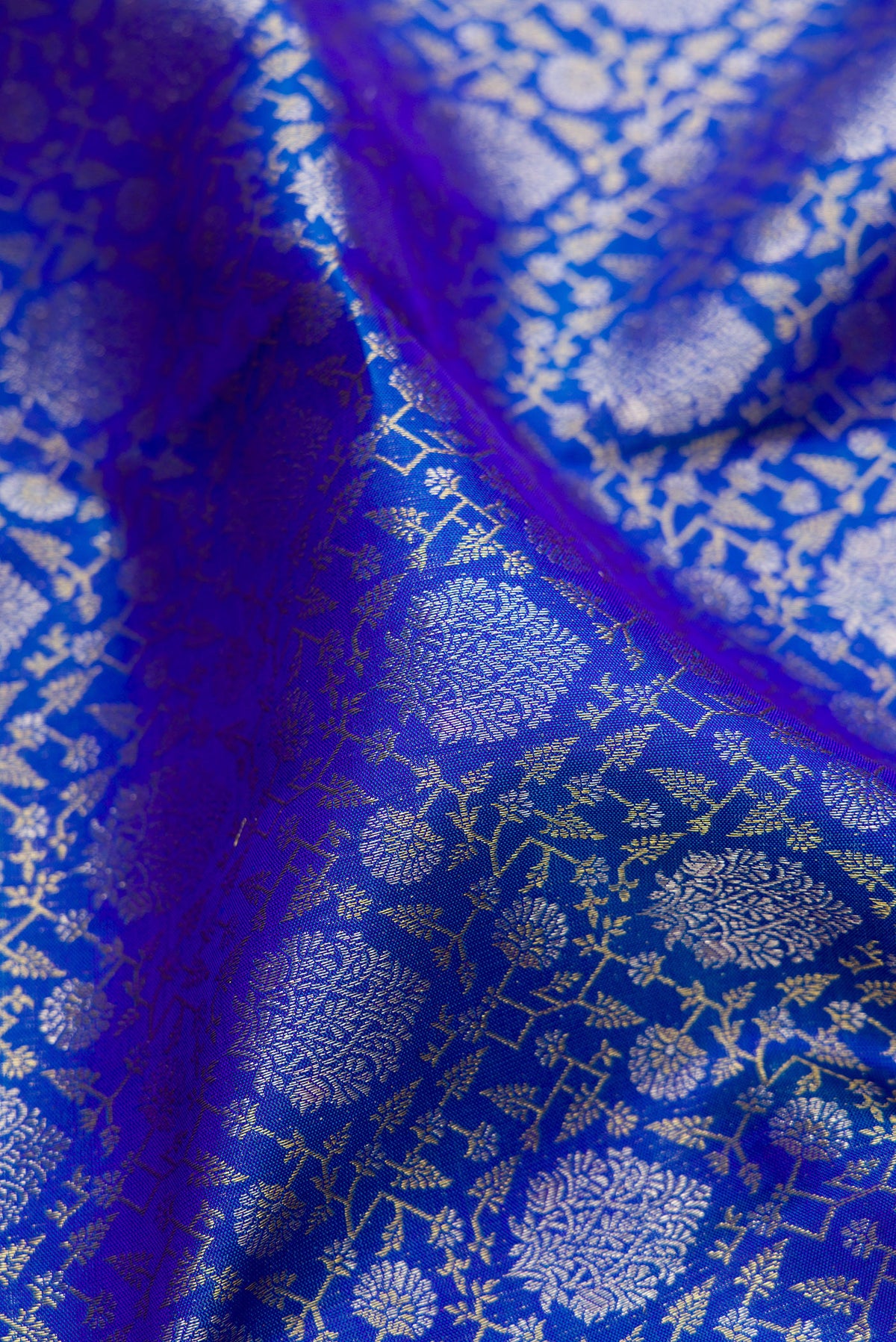 Close up of Pure Silk Royal Blue Kanchipuram Saree with Zari Brocade on the body and Zari Border.  displaying folds