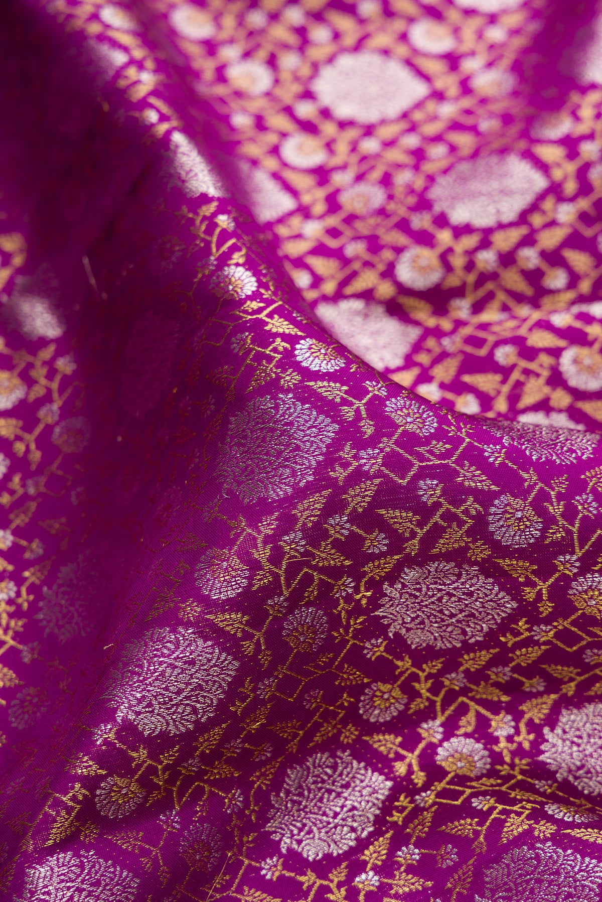 Close up of Pure Silk Magenta Kanchipuram Saree with Zari Brocade on the body and Zari Border.  displaying folds