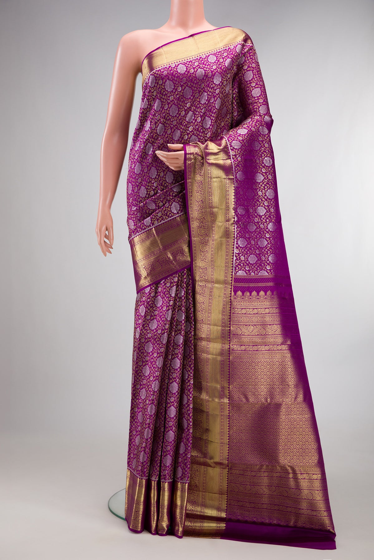 Pure Silk Magenta Kanchipuram Saree with Zari Brocade on the body and Zari Border.  displayed on a mannequin
