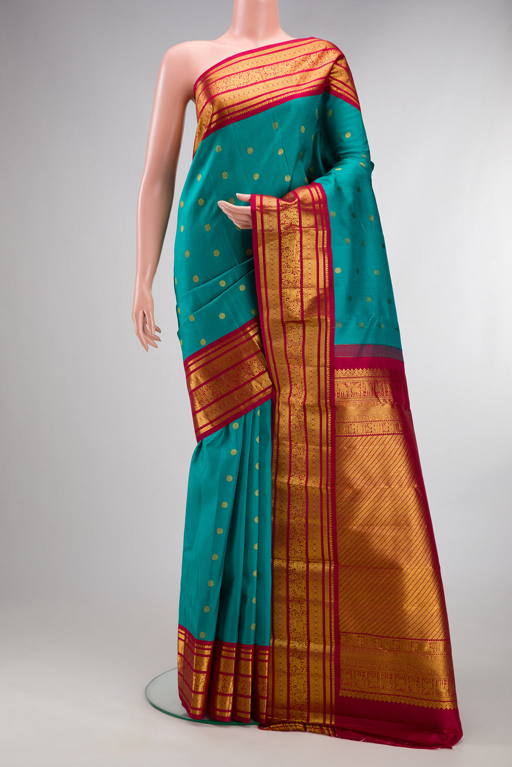 Pure Silk Green Dual Tone Kanjivaram Saree with Zari Butta on the body and Fancy Border.  displayed on a mannequin