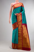 Pure Silk Green Dual Tone Kanjivaram Saree with Zari Butta on the body and Fancy Border.  displayed on a mannequin