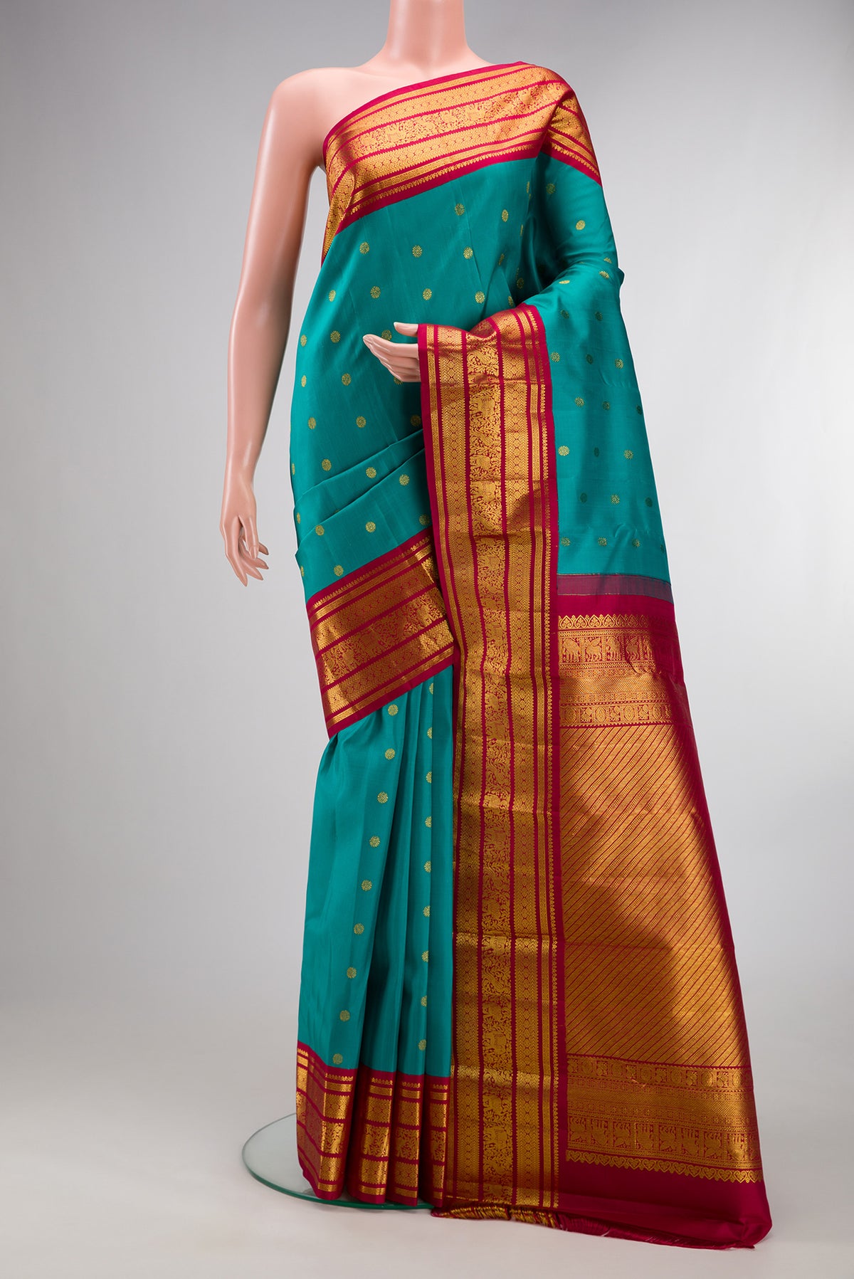 Pure Silk Green Dual Tone Kanjivaram Saree with Zari Butta on the body and Fancy Border.  displayed on a mannequin