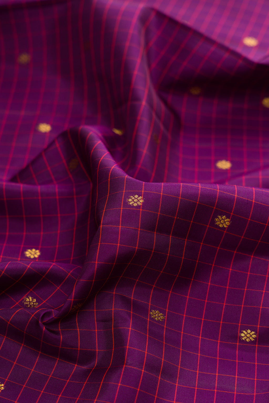 Close up of Pure Silk Purple Kanjivaram Saree with Checked design on the body and Zari Border.  displaying folds