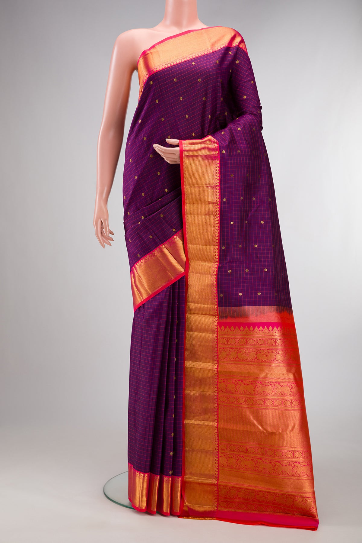 Pure Silk Purple Kanjivaram Saree with Checked design on the body and Zari Border.  displayed on a mannequin