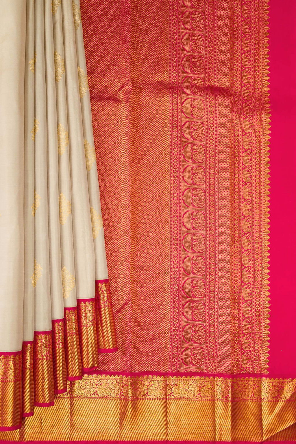 Pleats and pallu of Pure Silk Beige Kanjivaram Saree with Zari Butta on the body and Zari Border. 