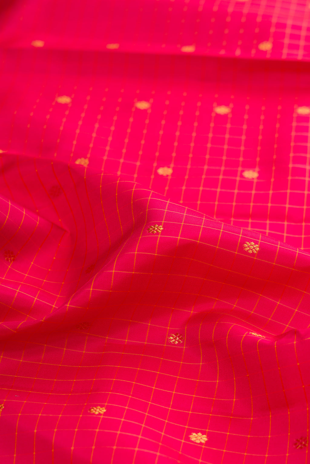 Close up of Pure Silk Pink Kanjivaram Saree with Checked design on the body and Zari Border.  displaying folds