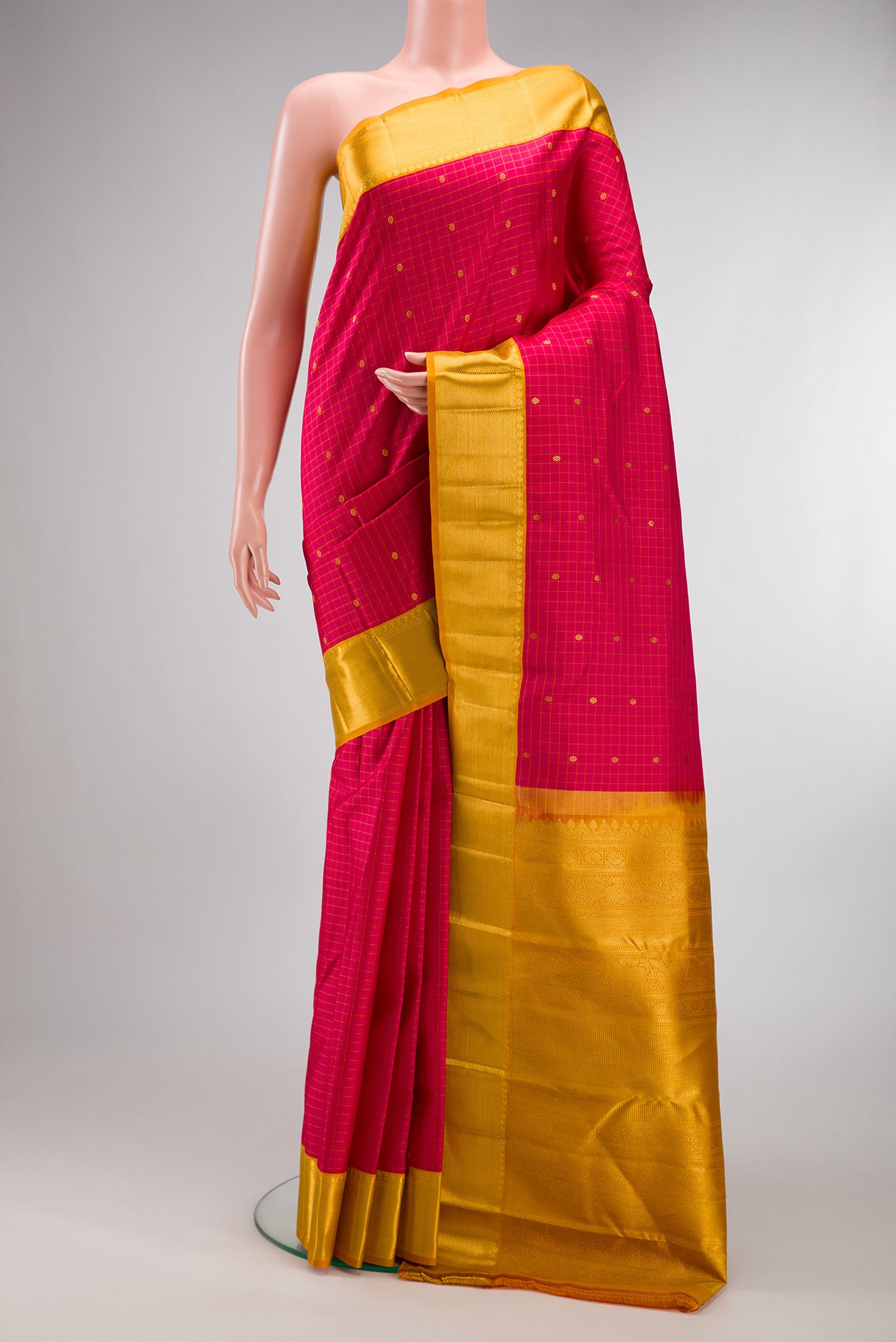 Pure Silk Pink Kanjivaram Saree with Checked design on the body and Zari Border.  displayed on a mannequin